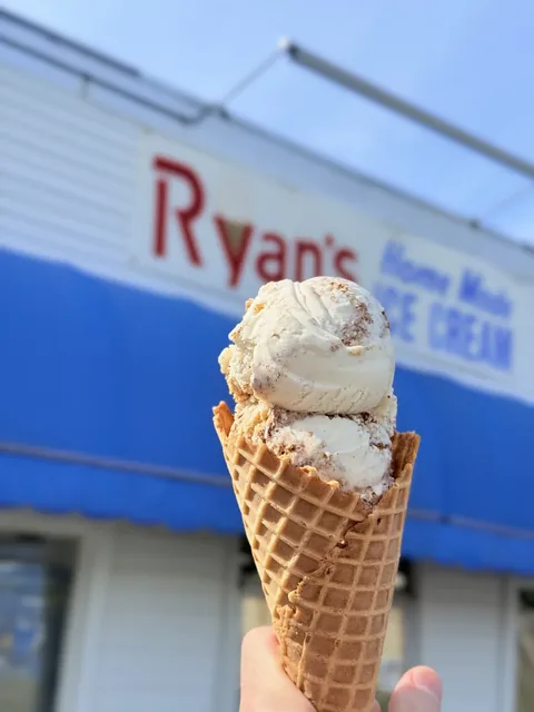 Homemade apple pie ice cream with crust pieces in a waffle cone