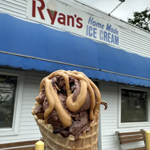 Waffle cone with chocolate ice cream and caramel drizzle