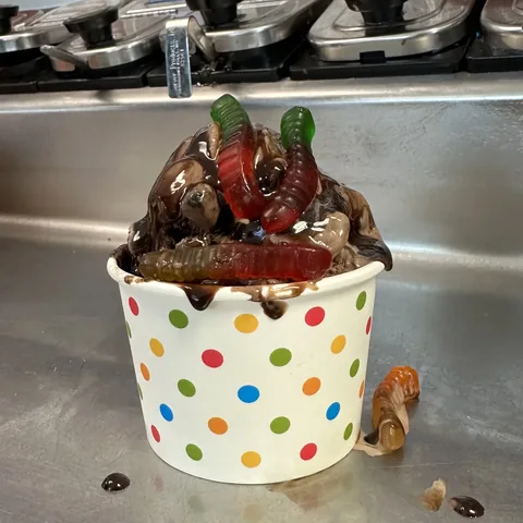 Dirt and worms sundae with chocolate ice cream fudge and gummy worms