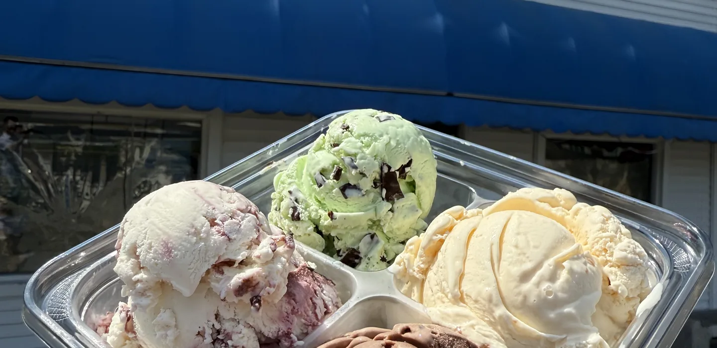 Flight sampler of four homemade ice cream flavors in front of Ryan's Homemade Ice Cream
