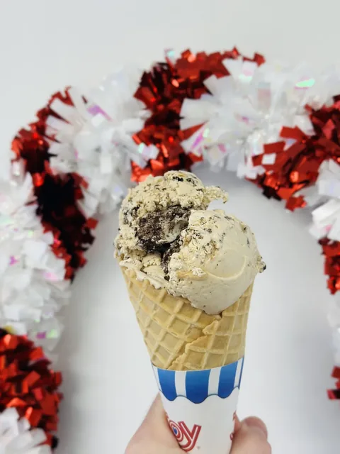 Vanilla soft serve twist cone with a festive holiday backdrop