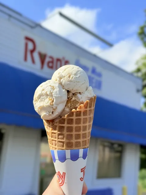 Homemade vanilla ice cream stacked high on a waffle cone