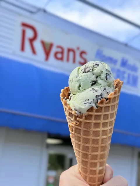 Mint chocolate chip ice cream piled high on a homemade waffle cone