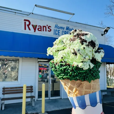 Mint ice cream waffle cone rimmed with green sprinkles