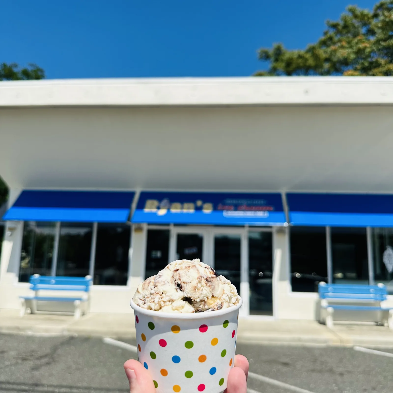 Ryan's Homemade Ice Cream shop storefront with blue awning and benches