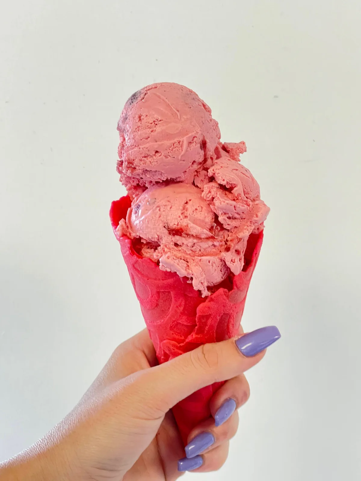 Strawberry ice cream scoops on a cone at Ryan's