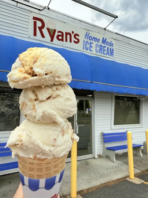 Towering double scoop of homemade vanilla ice cream on a cone